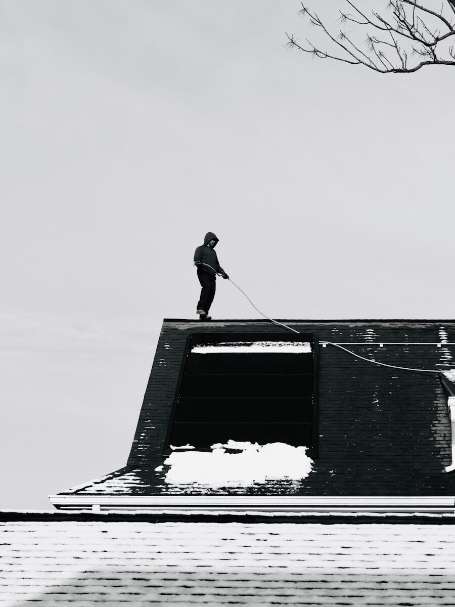 Person on a snowy rooftop with a rope